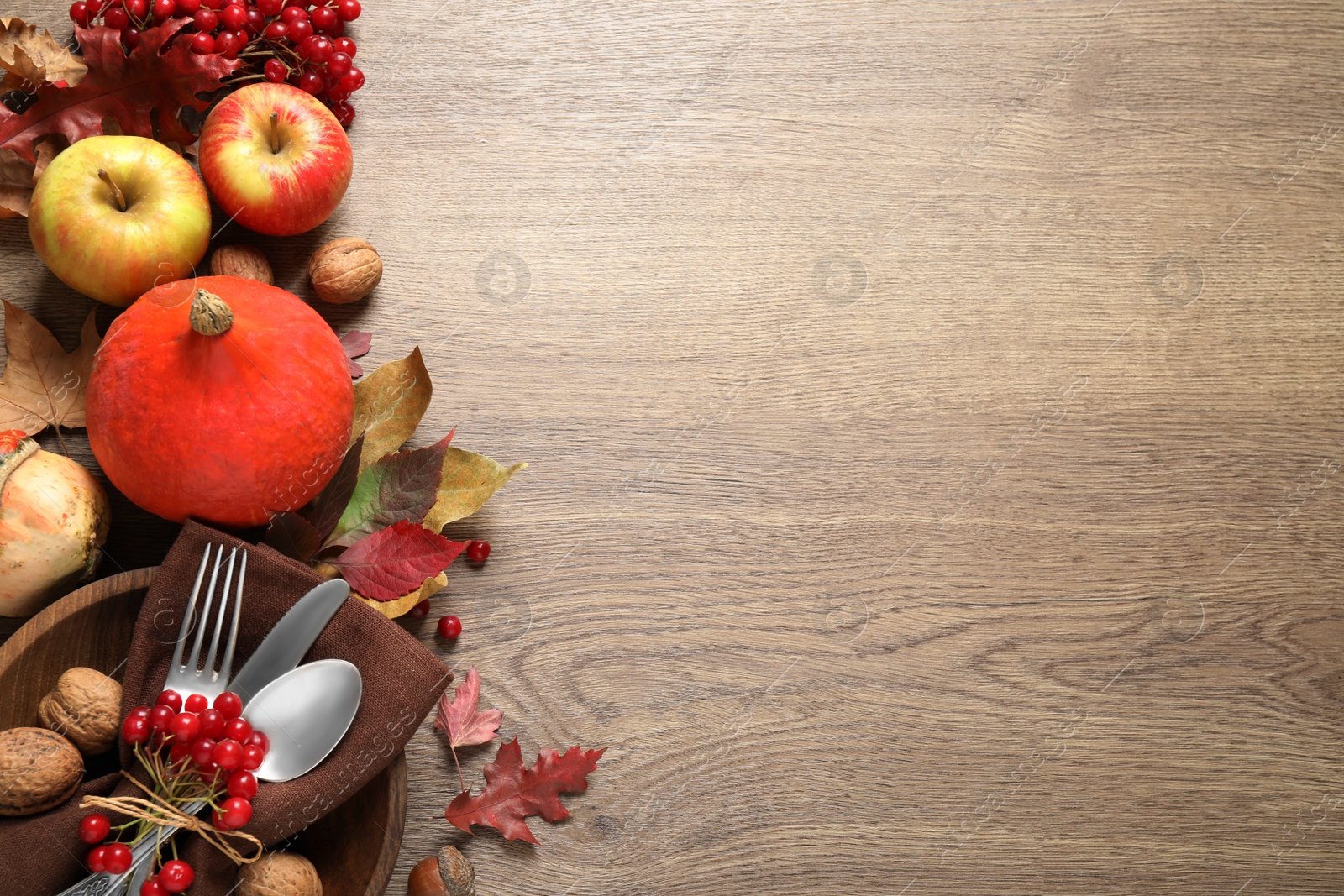 Photo of Autumn vegetables, fruits and cutlery on wooden background, flat lay with space for text. Happy Thanksgiving day