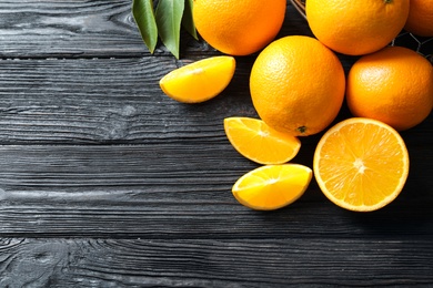 Photo of Flat lay composition with ripe oranges and space for text on wooden background