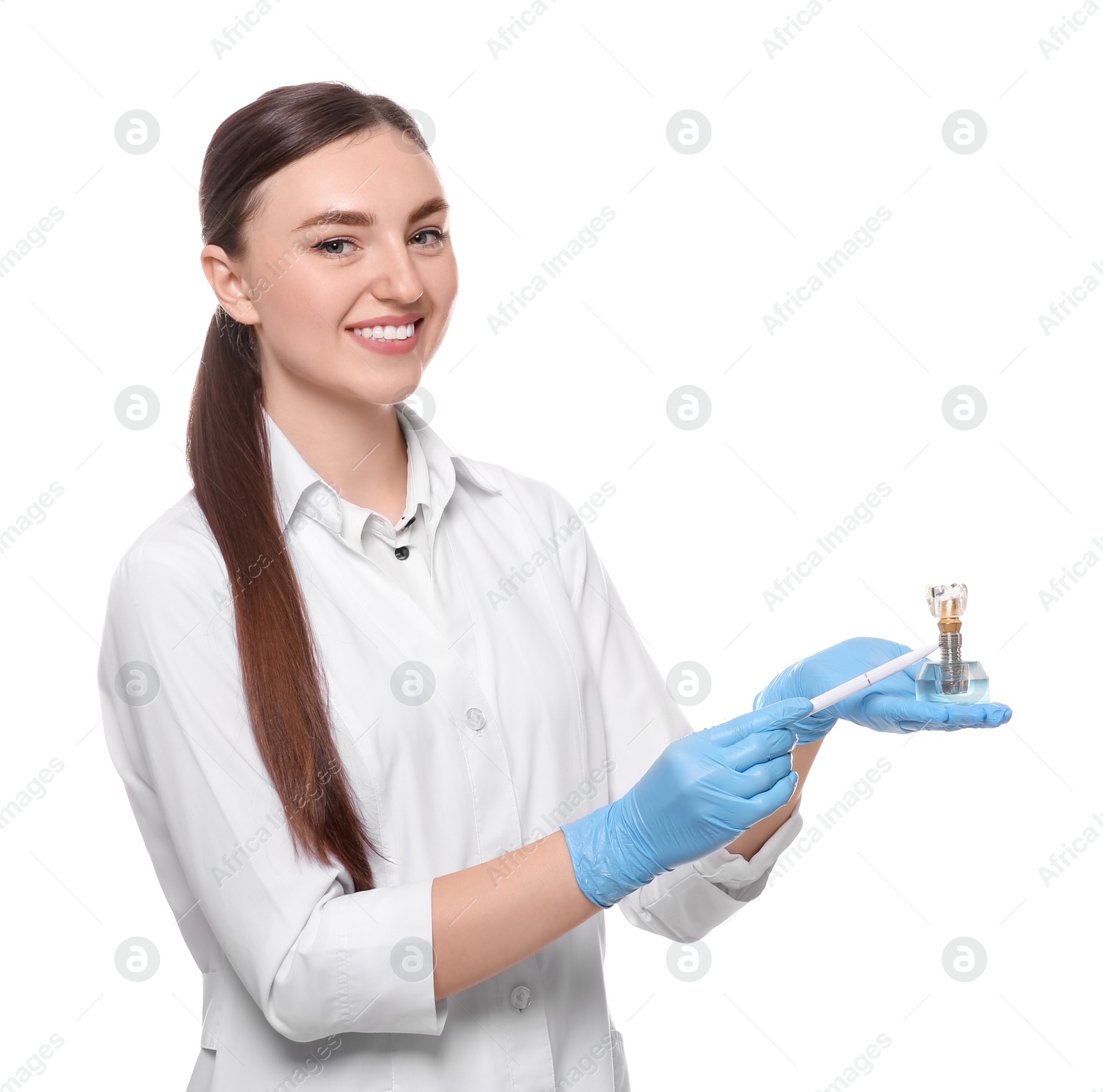 Photo of Dentist holding educational model of dental implant on white background