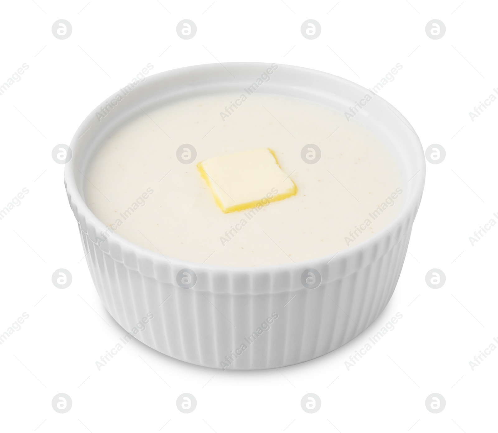 Photo of Bowl of delicious semolina pudding with butter isolated on white