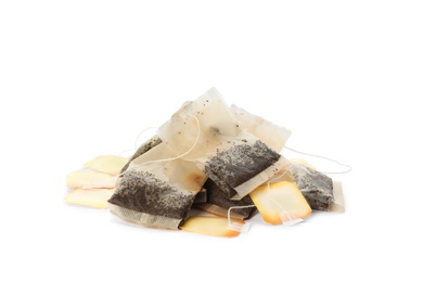 Photo of Many used tea bags on white background