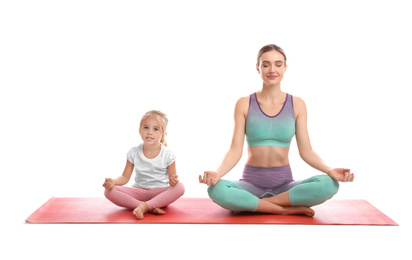 Young woman and her daughter doing exercise isolated on white. Home fitness