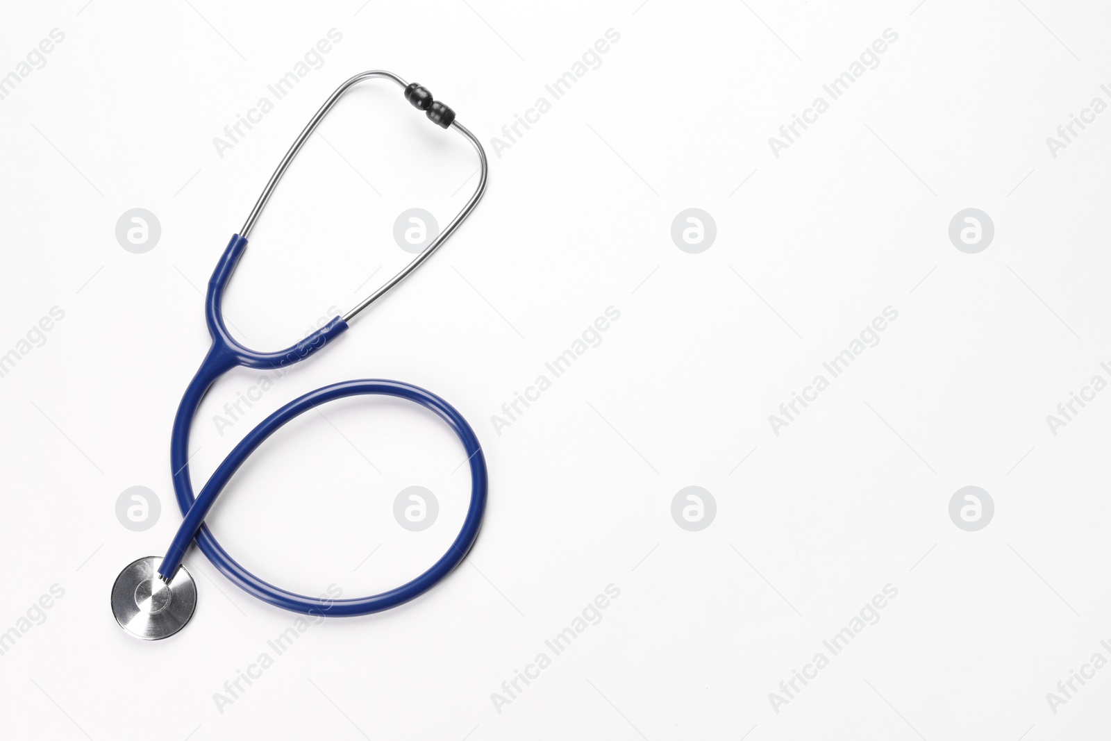 Photo of New stethoscope on white background, top view. Medical instrument