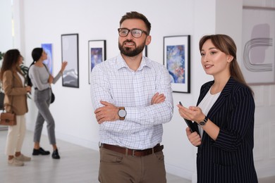 Photo of Happy couple at exhibition in art gallery