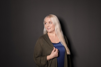 Photo of Portrait of mature woman on black background