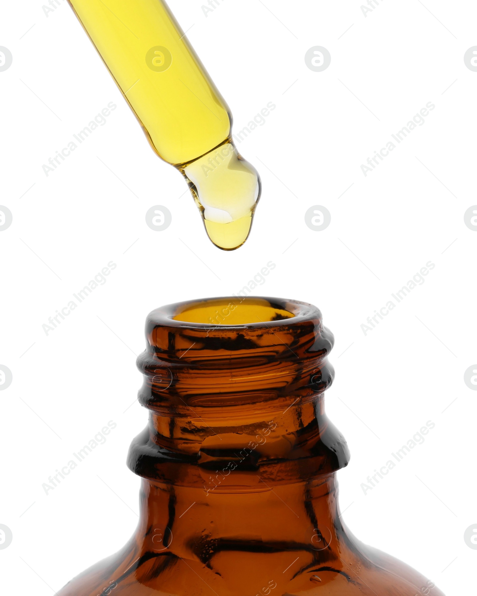 Photo of Dripping tincture from pipette into bottle isolated on white