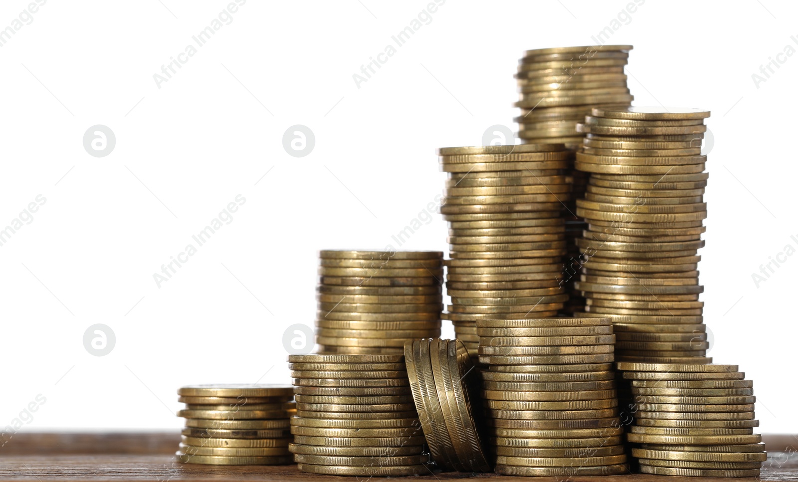 Photo of Stack of coins on wooden table, closeup. Space for text