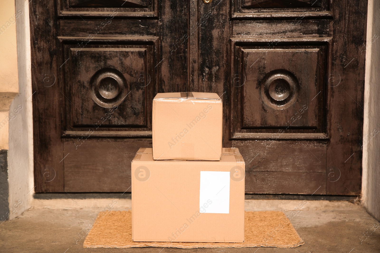 Photo of Delivered parcels on door mat near entrance