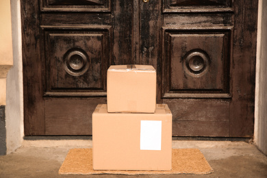 Photo of Delivered parcels on door mat near entrance