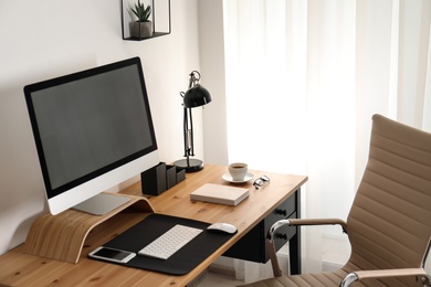 Photo of Stylish workplace interior with modern computer on table. Mockup for design