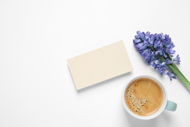 Photo of Blank card, coffee and hyacinth flowers on white background, top view. Good morning