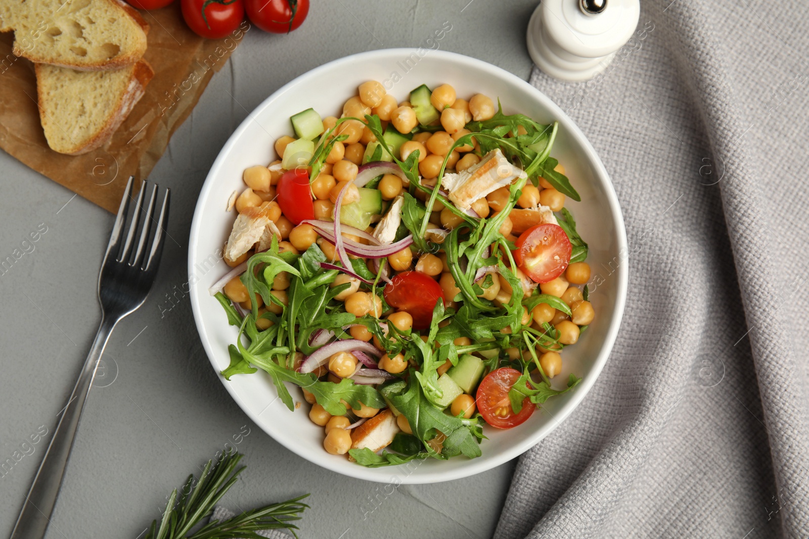 Photo of Delicious fresh chickpea salad served on light grey table, flat lay