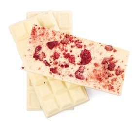 Chocolate bars with freeze dried raspberries on white background, top view