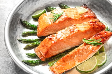 Tasty freshly cooked salmon in frying pan, closeup