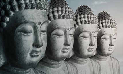 Image of Row of stone Buddha sculptures. World religion