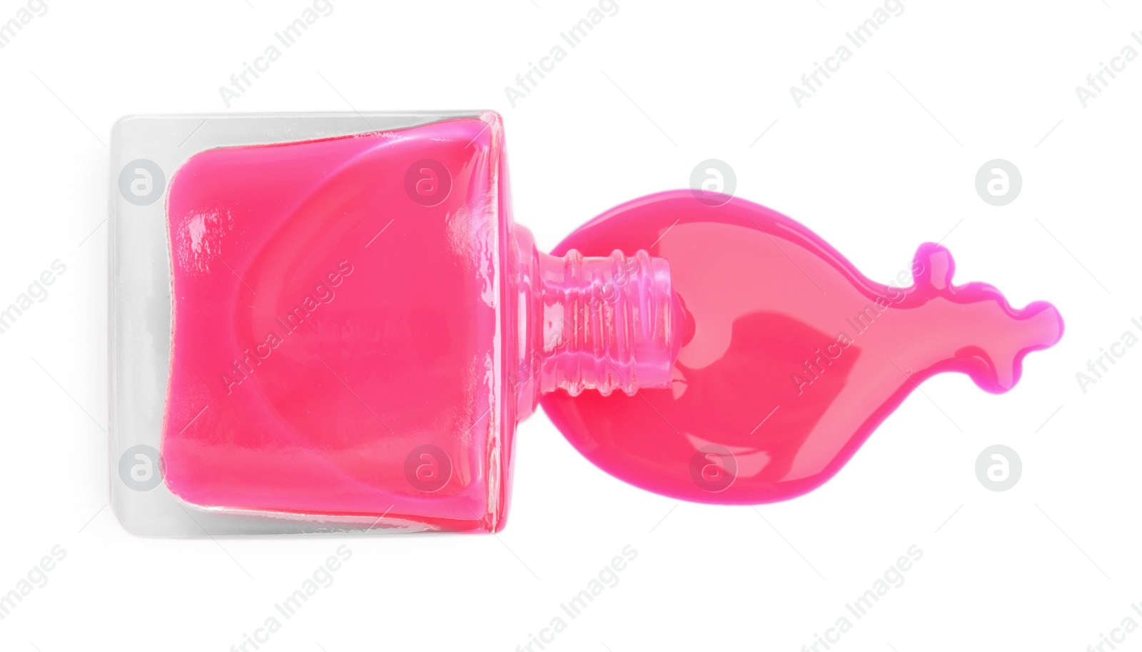 Photo of Overturned bottle of pink nail polish isolated on white, top view