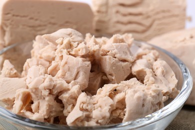 Photo of Pieces of compressed yeast in glass bowl, closeup