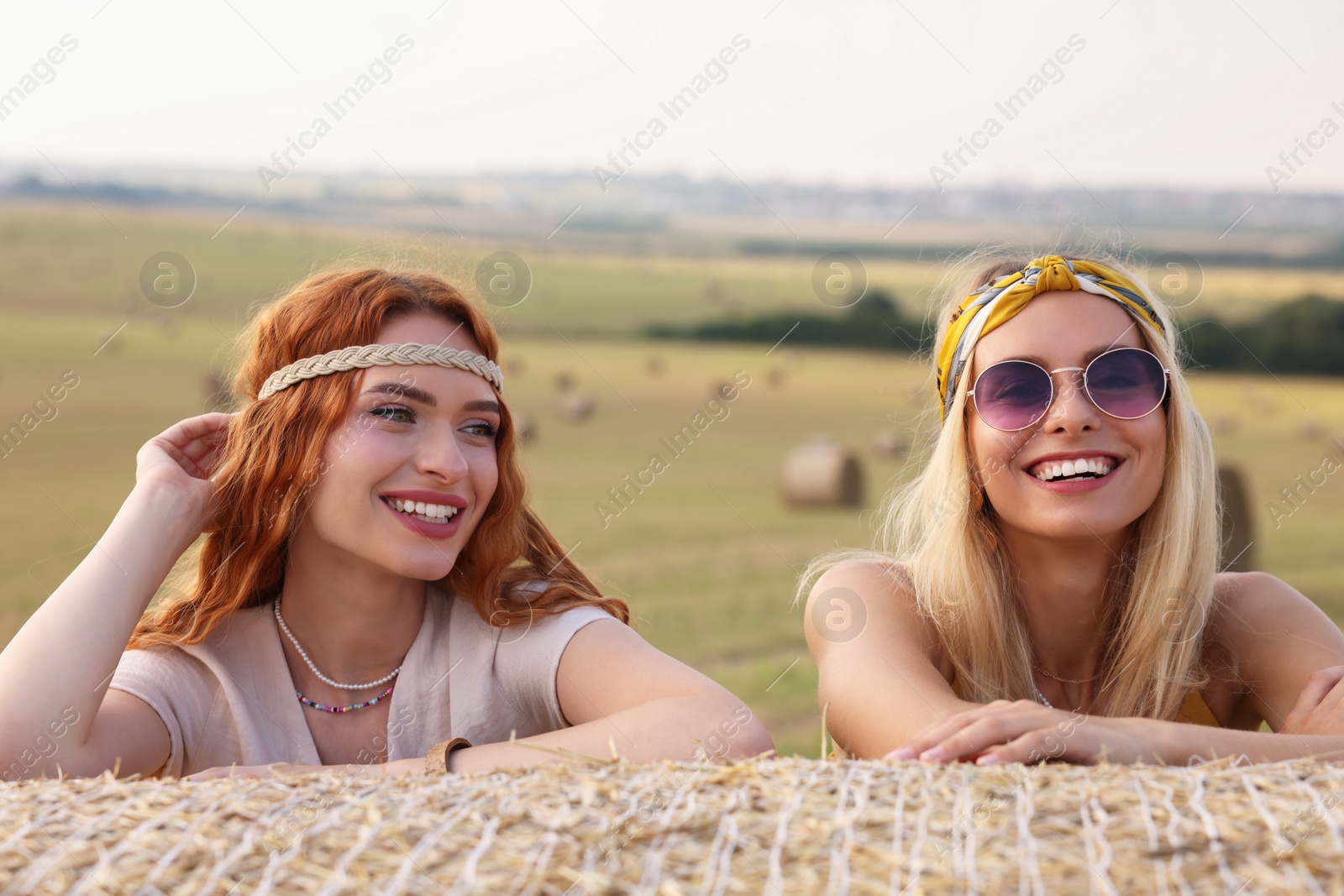 Photo of Portrait of beautiful happy hippie women in field