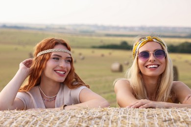 Portrait of beautiful happy hippie women in field