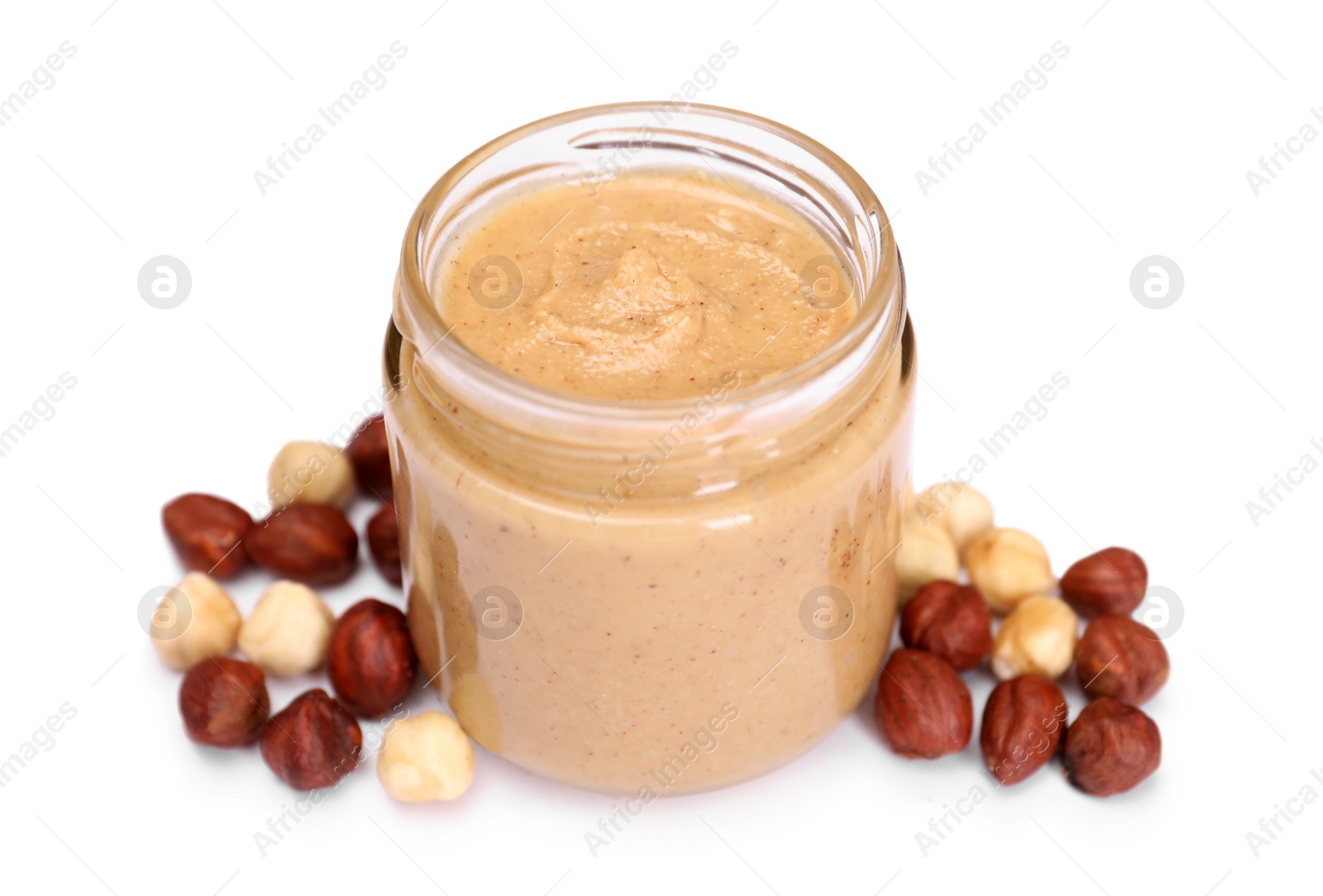 Photo of Tasty nut paste in jar and hazelnuts isolated on white