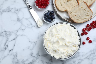 Tasty cream cheese, fresh berries and bread on white marble table, flat lay. Space for text