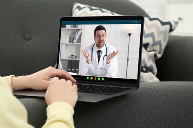 Image of Online medical consultation. Woman having video chat with doctor via laptop at home, closeup