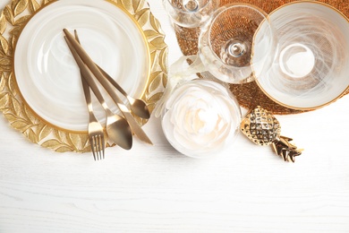 Photo of Elegant table setting and space for text on light background, top view