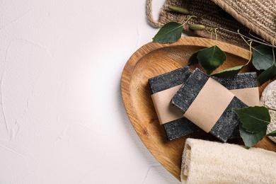 Photo of Flat lay composition with natural tar soap on white table, space for text