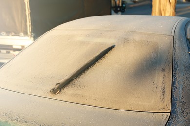 Photo of White car covered with hoarfrost outdoors in morning, closeup