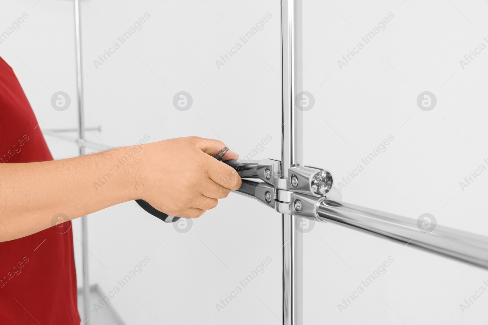 Photo of Worker installing new metal pipes indoors, closeup