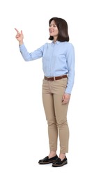 Happy businesswoman in blue shirt and beige pants on white background