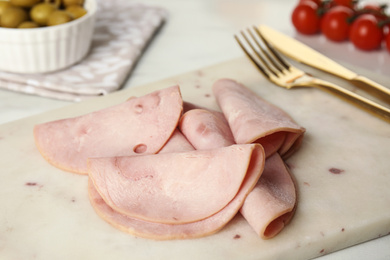 Photo of Slices of tasty ham on table, closeup