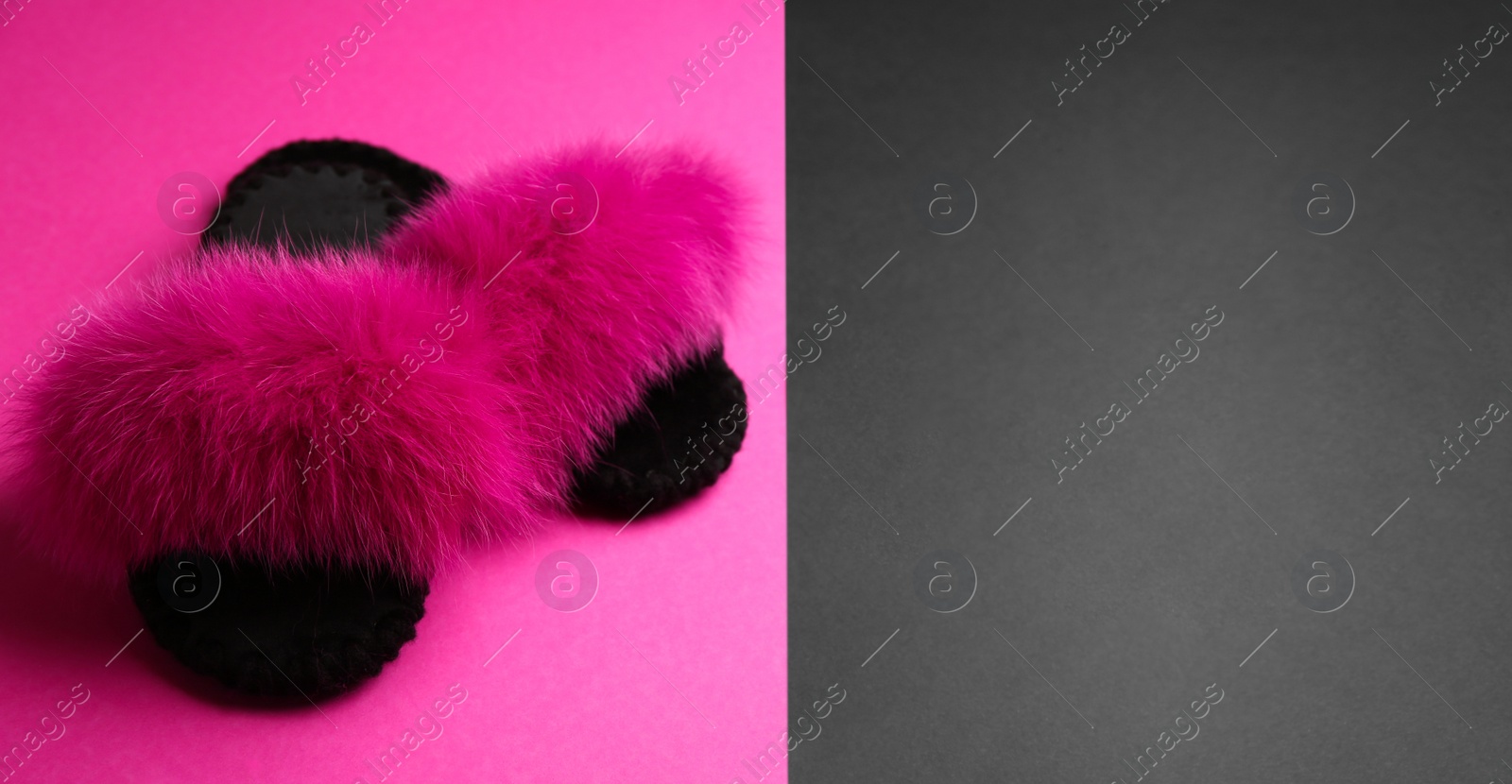 Photo of Pair of soft slippers on color background. Space for text