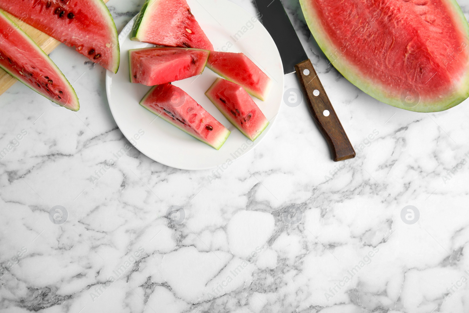 Photo of Yummy watermelon on white marble table, flat lay. Space for text