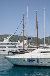 Beautiful view of different boats in sea near shore on sunny day