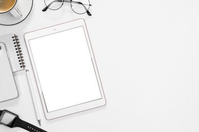 Photo of Flat lay composition with modern tablet on white background. Space for text