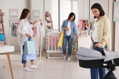 Happy pregnant women with shopping bags in store