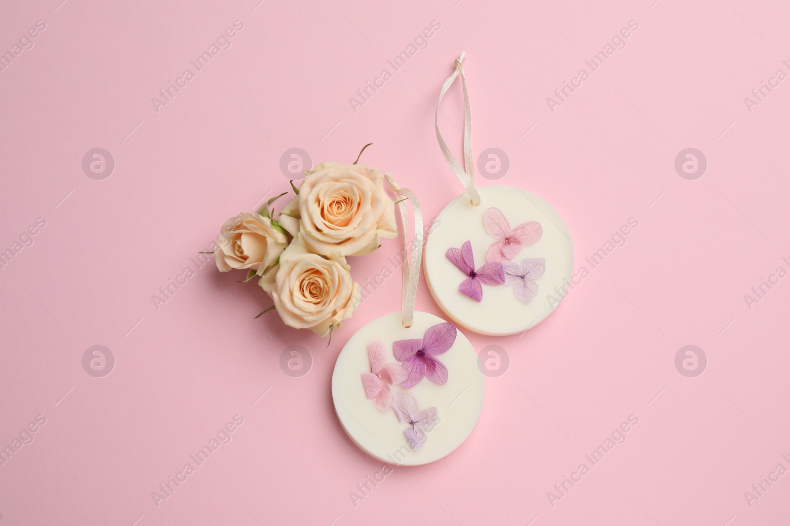 Photo of Flat lay composition with scented sachets on pink background