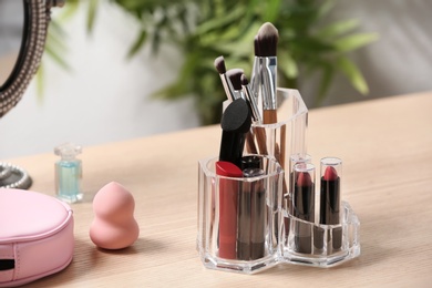 Photo of Set of decorative cosmetic products for makeup on dressing table. Space for text