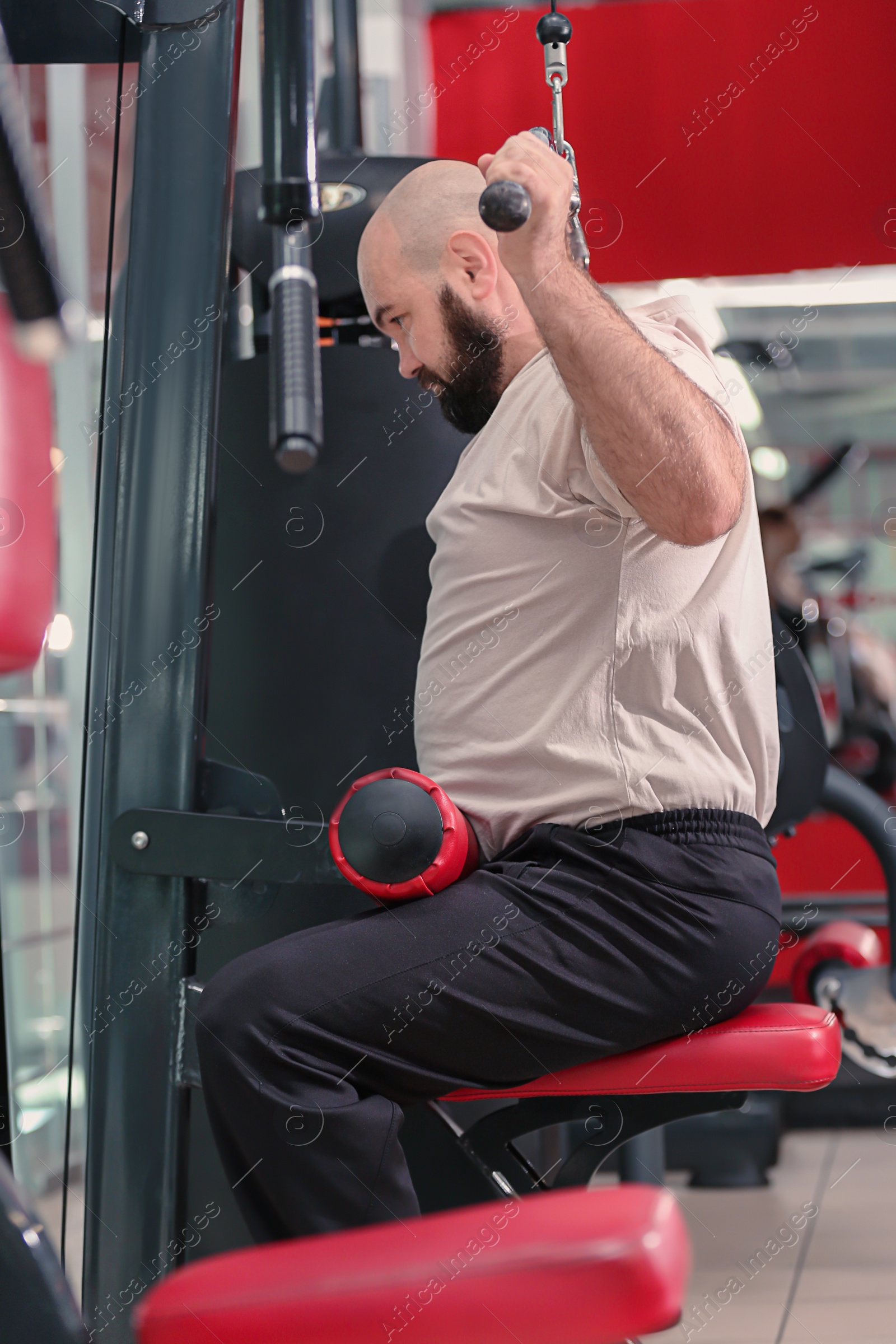 Photo of Overweight man training in gym