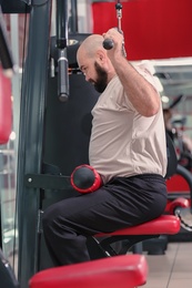 Overweight man training in gym