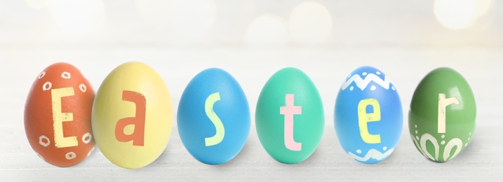 Image of Happy Easter. Colorful dyed eggs on light background, banner design