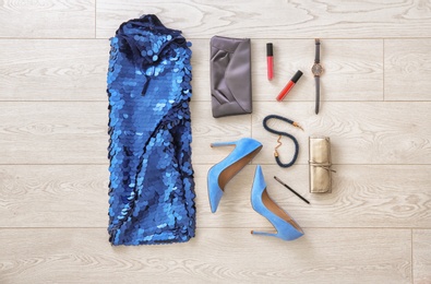 Photo of Set of female clothes and accessories on wooden background, flat lay