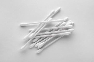 Photo of Heap of clean cotton buds on white background, top view