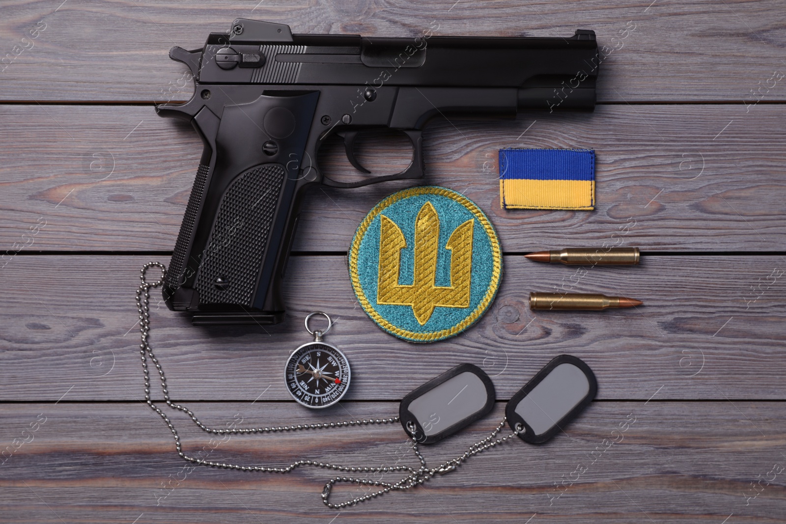 Photo of MYKOLAIV, UKRAINE - SEPTEMBER 19, 2020: Flat lay composition with Ukraine military equipment on grey wooden table