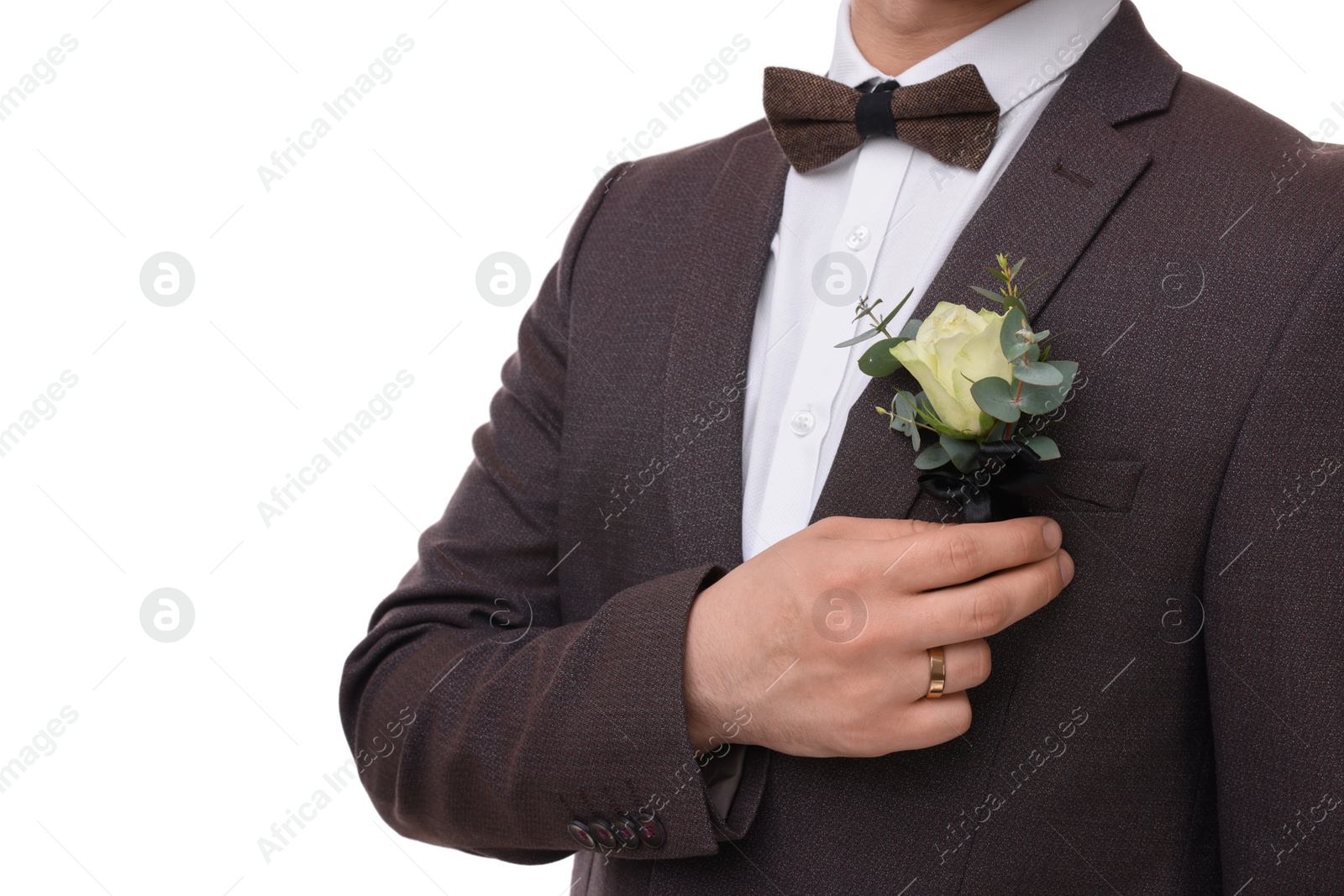 Photo of Groom with boutonniere on white background, closeup. Wedding accessory