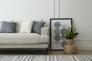 Photo of Stylish beige sofa in living room interior