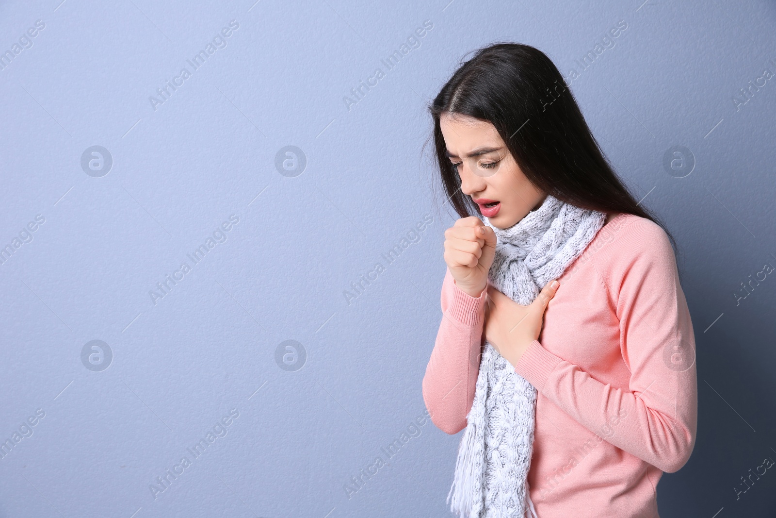 Photo of Young woman coughing on color background