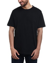 Smiling man in black t-shirt on white background, closeup