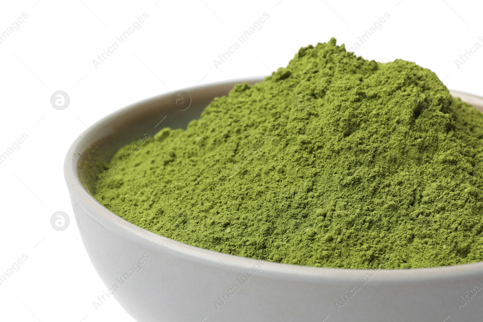 Photo of Green matcha powder in bowl isolated on white